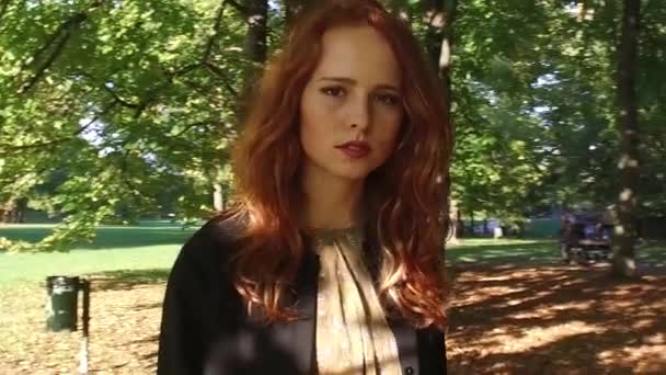 Young woman walking outdoors in sunny park - Footage, Video
