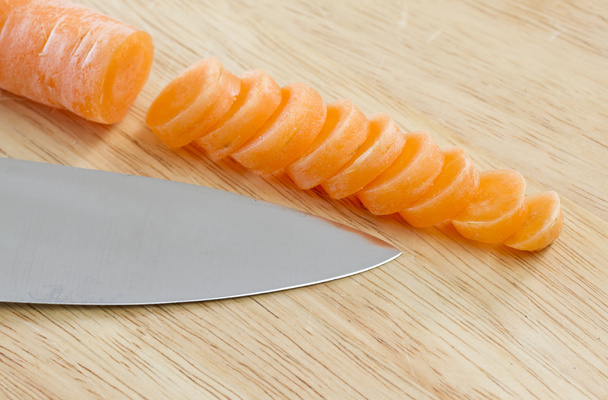 Carrot sliced on wooden chopping board - Zdjęcie, obraz