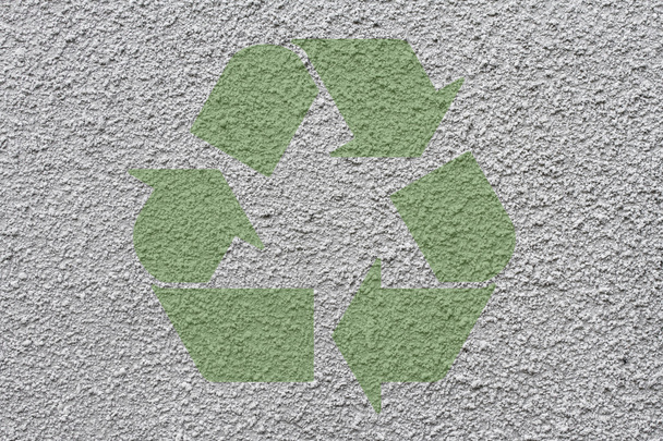 Green recycle symbol on stucco walll - Photo, Image