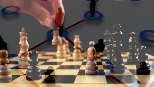 Digital composite of a man playing chess while background shows silhouette of business people connected by lines - Materiał filmowy, wideo