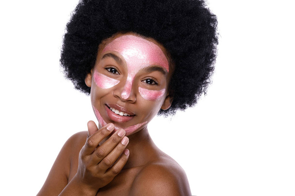 Young African woman with a purifying mask on her face  - 写真・画像