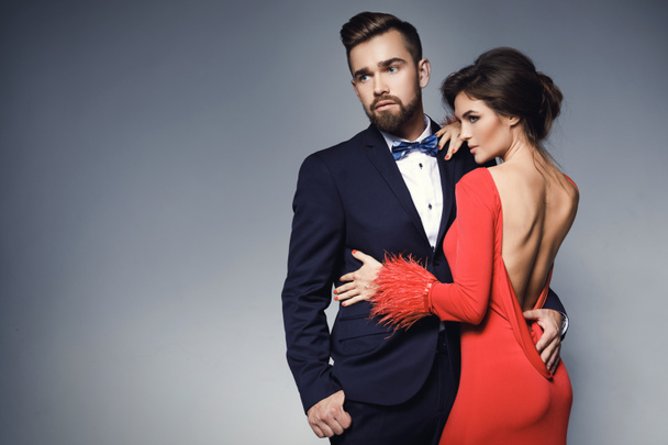 Woman in beautiful red dress and man wearing blue classical suit - Fotografie, Obrázek