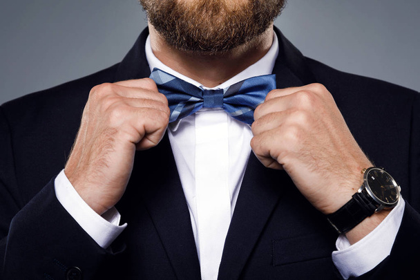Man is fiting up a beautiful bow tie  - Photo, Image