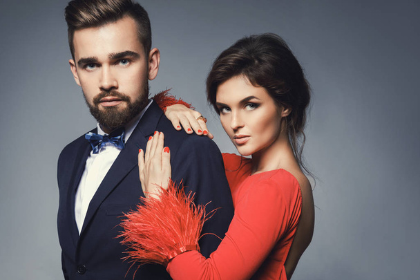 Woman in beautiful red dress and man wearing blue classical suit - Foto, imagen
