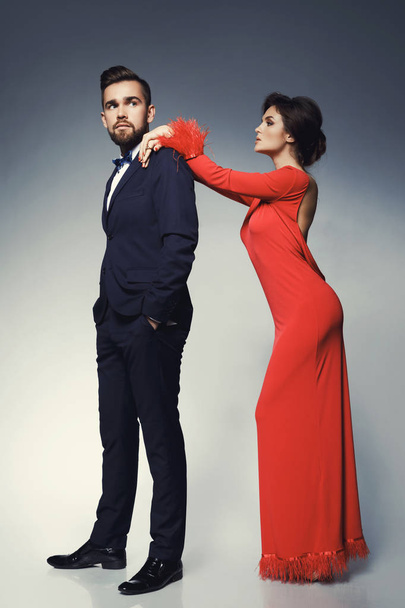 Woman in beautiful red dress and man wearing blue classical suit - Valokuva, kuva