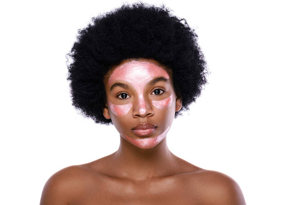 Young African woman with a purifying mask on her face  - Fotó, kép