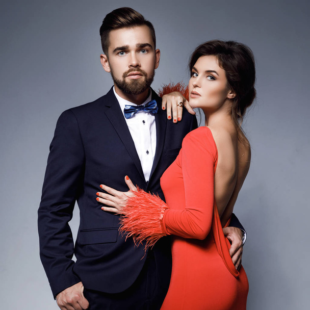 Woman in beautiful red dress and man wearing blue classical suit - Fotoğraf, Görsel