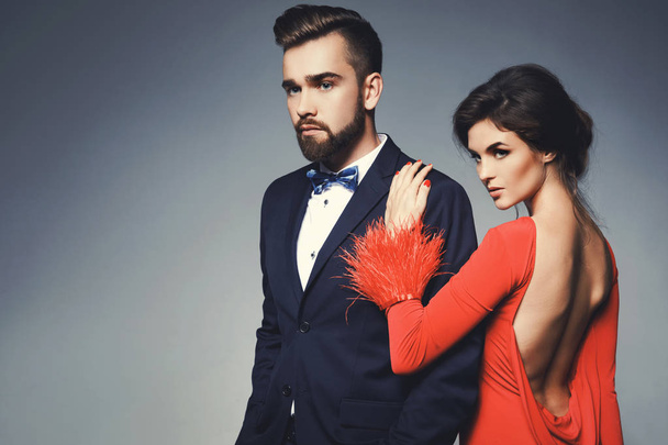 Woman in beautiful red dress and man wearing blue classical suit - Foto, afbeelding