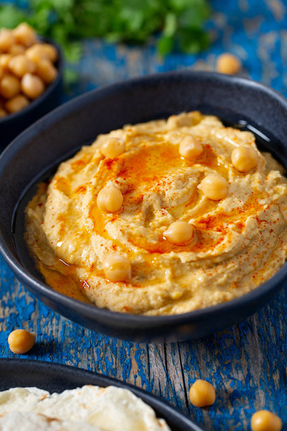 hummus on a wooden surface - Photo, image