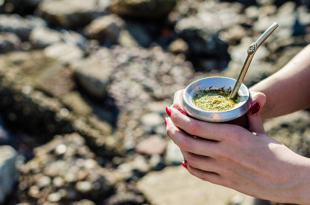 Giovane donna che beve tè tradizionale argentino yerba mate dalla zucca calabash
 - Foto, immagini