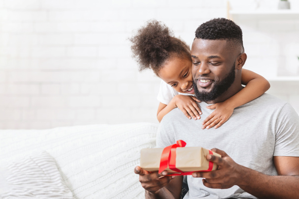 Adorable little african american girl embracing her father - Photo, Image