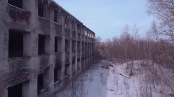 Flight over the abandoned building, Old destroyed building in a winter season. Aerial view 4K - Materiaali, video