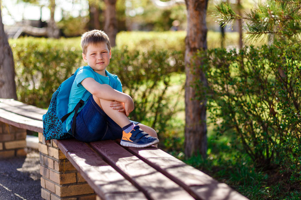 happy smiling boy in sneakers and backpack - Photo, image