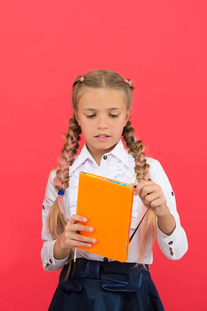 Stationery admirer. Schoolgirl show notepad. School supplies concept. School stationery. Buy cute stationery for fun studying. Girls famous for obsession with stationery. Kid school uniform hold book - Foto, immagini