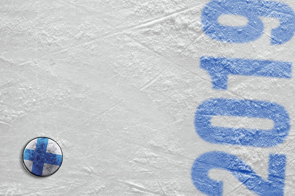 Hockey puck with the image of the Finnish flag lying on the ice  - Zdjęcie, obraz