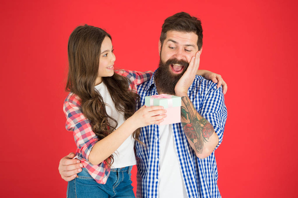For best dad ever. Celebrate fathers day. Family values concept. Friendly relations. Father hipster and his daughter. Gift surprise. Man bearded father and cute little girl daughter on red background - Fotó, kép