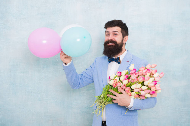 Hurry up to enjoy the spring. bride groom at wedding party. spring bouquet. hipster with beard. love date with flowers. womens day. Formal mature businessman bearded man in bow tie with tulip flowers - Photo, Image