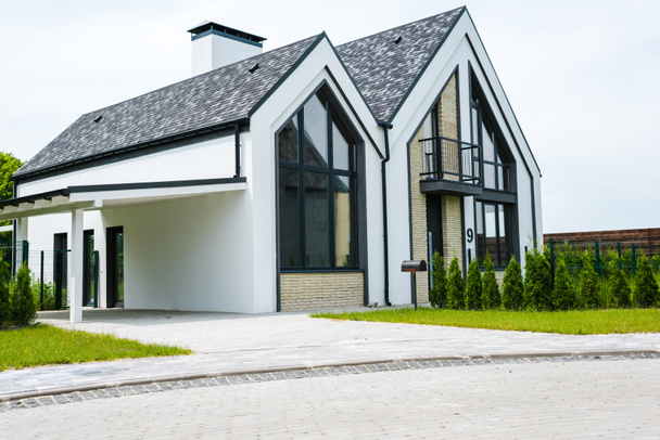 new modern and luxury home with windows and doors near green grass  - Zdjęcie, obraz