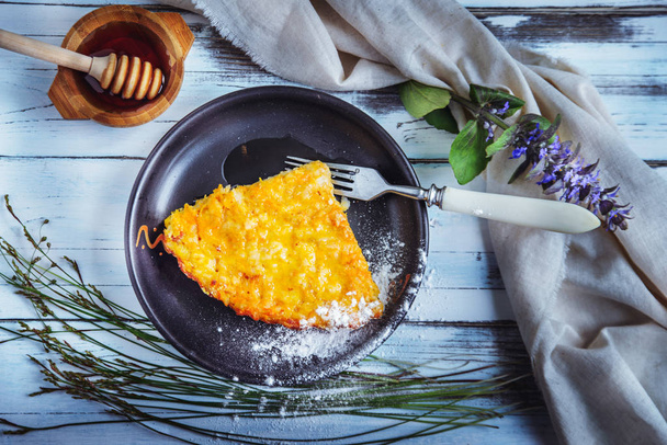 the piece of vegetarian carrot pie on a dark clay plate is locat - Photo, Image