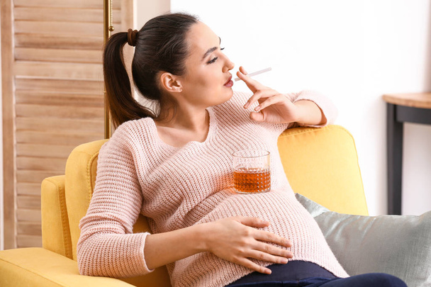 Pregnant woman smoking at home - Φωτογραφία, εικόνα