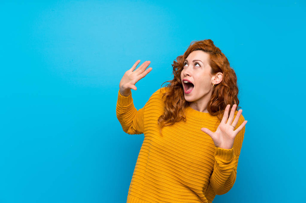 Redhead woman with yellow sweater nervous and scared - Photo, Image