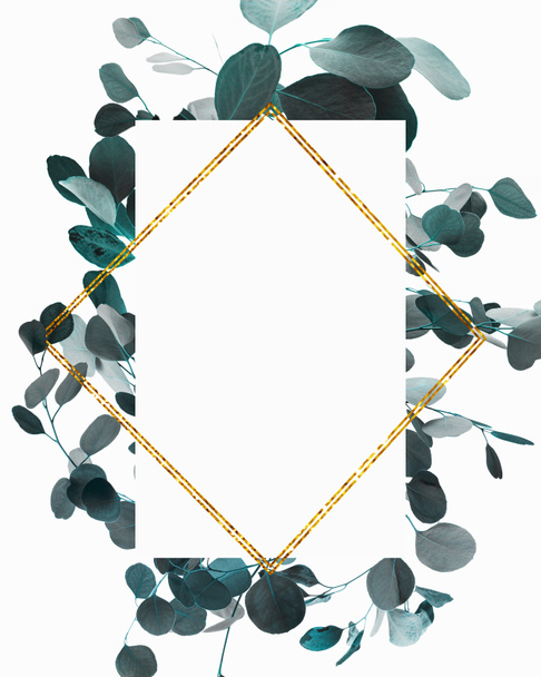 Floral design with green eucalyptus branches and golden frame - Foto, afbeelding