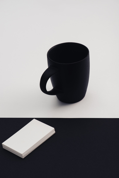 white business cards and black coffee cup on black and white background - Φωτογραφία, εικόνα
