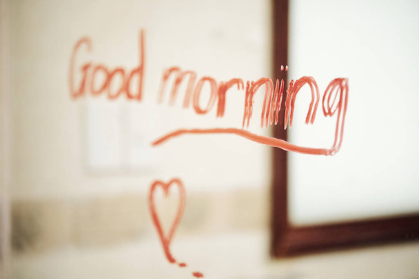 Image of text Good morning written with red lipstick on the mirror in bathroom - Foto, Imagen