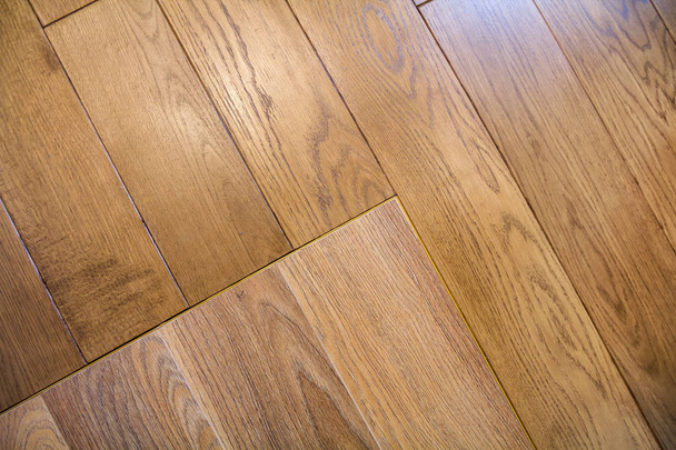 Natural light brown wooden parquet floor boards. Sunny soft yell - Фото, изображение