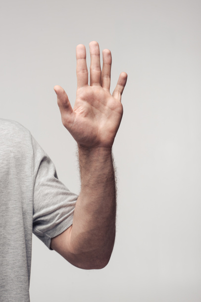 visão parcial do homem mostrando gesto stop isolado em cinza, emoção humana e conceito de expressão
 - Foto, Imagem