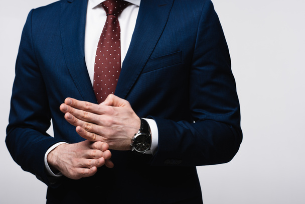 partial view of confident businessman showing stop gesture isolated on grey, human emotion and expression concept - Photo, Image