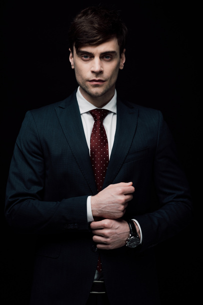 serious businessman looking at camera isolated on black - Фото, зображення