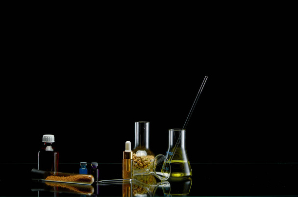 Medical flasks with different liquid on black background - Fotografie, Obrázek