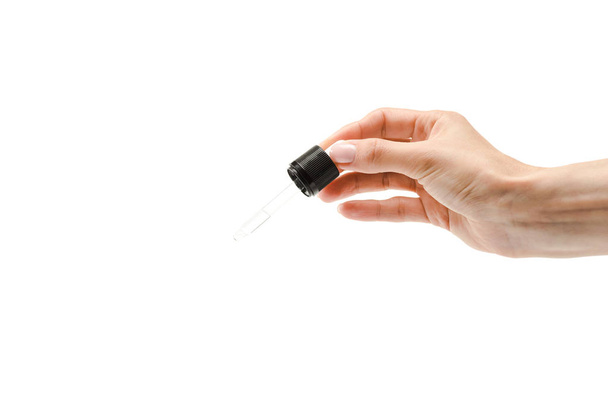 cropped view of woman holding pipette with liquid isolated on white  - Foto, afbeelding