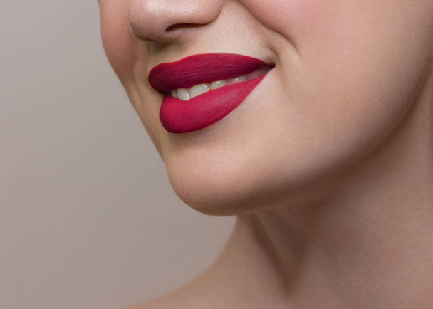 Close-up of woman's lips with fashion bright pink make-up. Beautiful female mouth, full lips with perfect makeup. Part of female face. Choice lipstick. Pink wavy hair of a doll - Fotó, kép