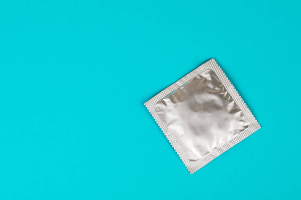 Kondom auf blauem Hintergrund. Das Konzept des Safe Sex. - Foto, Bild