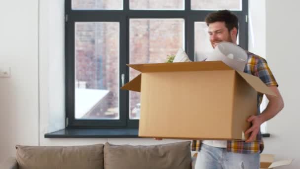 happy man with box moving to new home - Video, Çekim