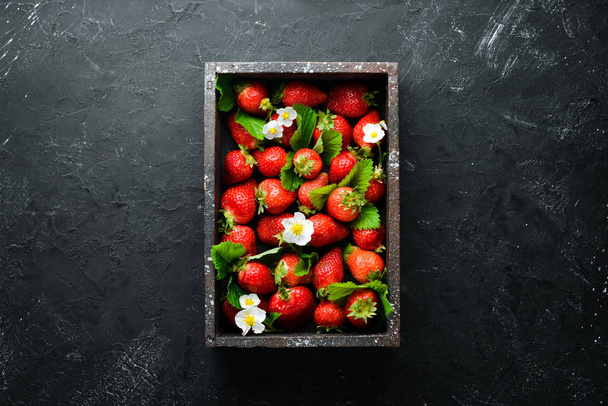 Fresh strawberries in a wooden box. Berries Top view. Free space for your text. - Фото, изображение