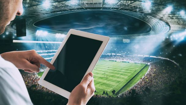 Mann mit Tablet im Stadion, um auf das Spiel zu wetten - Foto, Bild