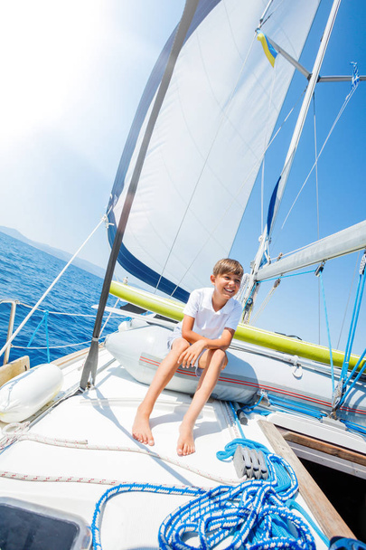 Little boy on board of sailing yacht on summer cruise. Travel adventure, yachting with child on family vacation. - Fotografie, Obrázek