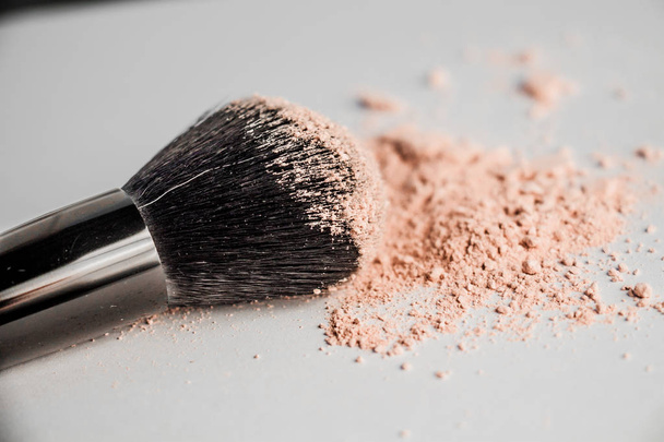cosmetic powder slide and black makeup brush - Фото, зображення