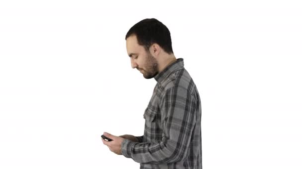 Young smart casual business man reading message on cell phone on white background. - Footage, Video