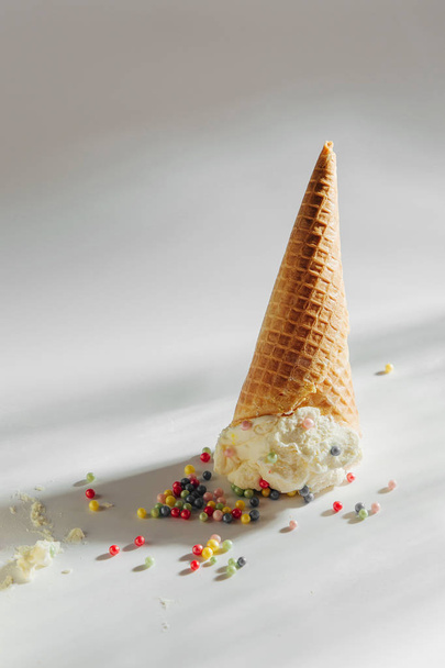Ice cream cone fallen on white background.  - Valokuva, kuva