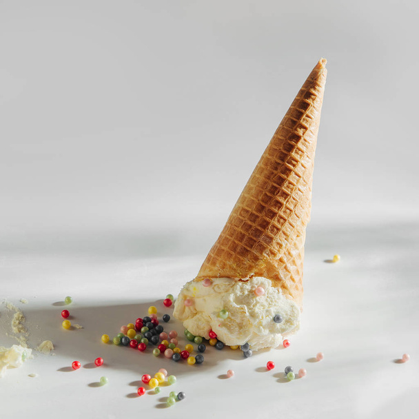 Ice cream cone fallen on white background.  - Foto, Imagem
