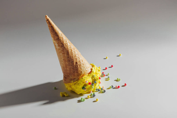 Ice cream cone fallen on white background.  - 写真・画像