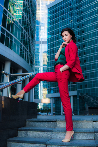 Street fashion business style, attractive model on skyscrapers background. Success concept - Photo, Image