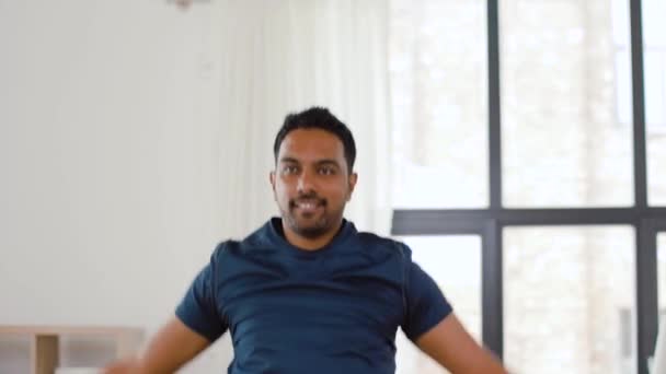 indian man doing jumping jack exercise at home - Metraje, vídeo