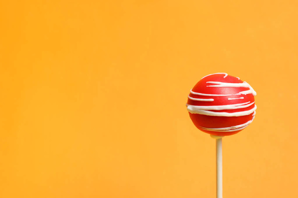 Bright delicious cake pop on color background. Space for text - Zdjęcie, obraz