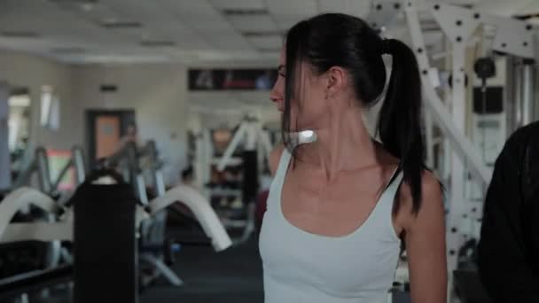 Adult overweight man and beautiful woman dancing with barbells in the gym. - Filmati, video