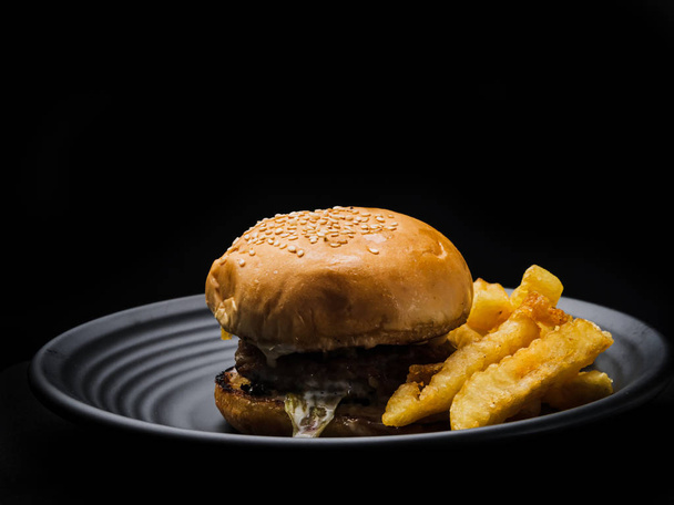 Hamburger in black background. - Photo, Image